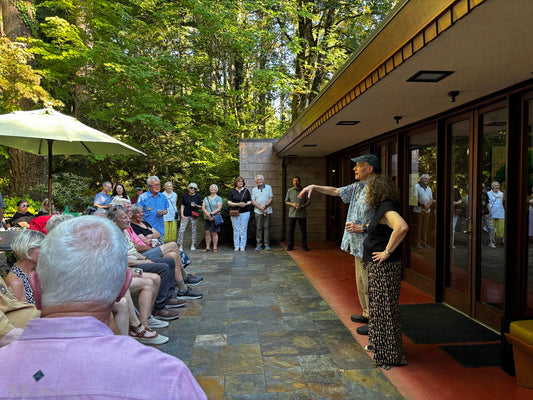 Sammamish Rotary members gather on the patio of the Brandes House while John and Marsha Shyer speak to the group.